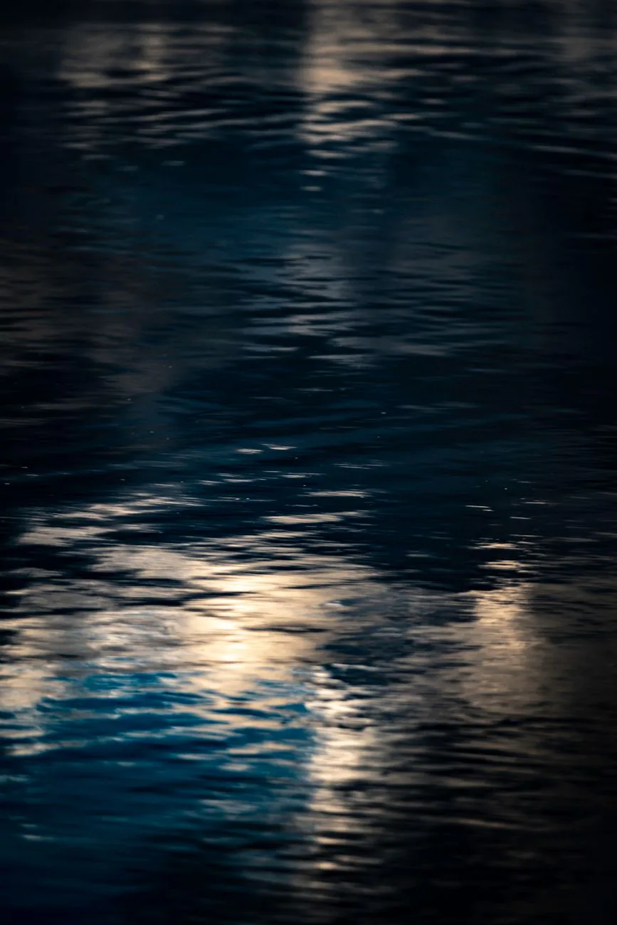 Faint reflections on moody dark water