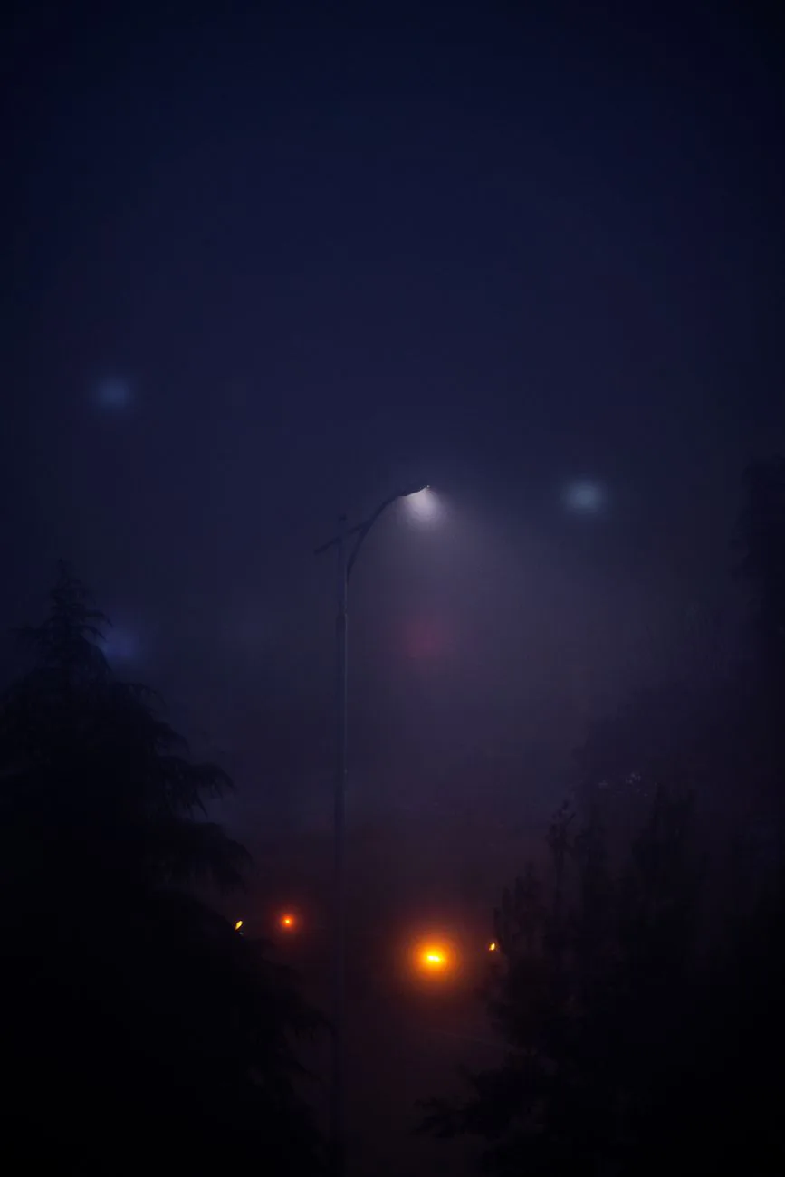 A soft glow diffused through night fog