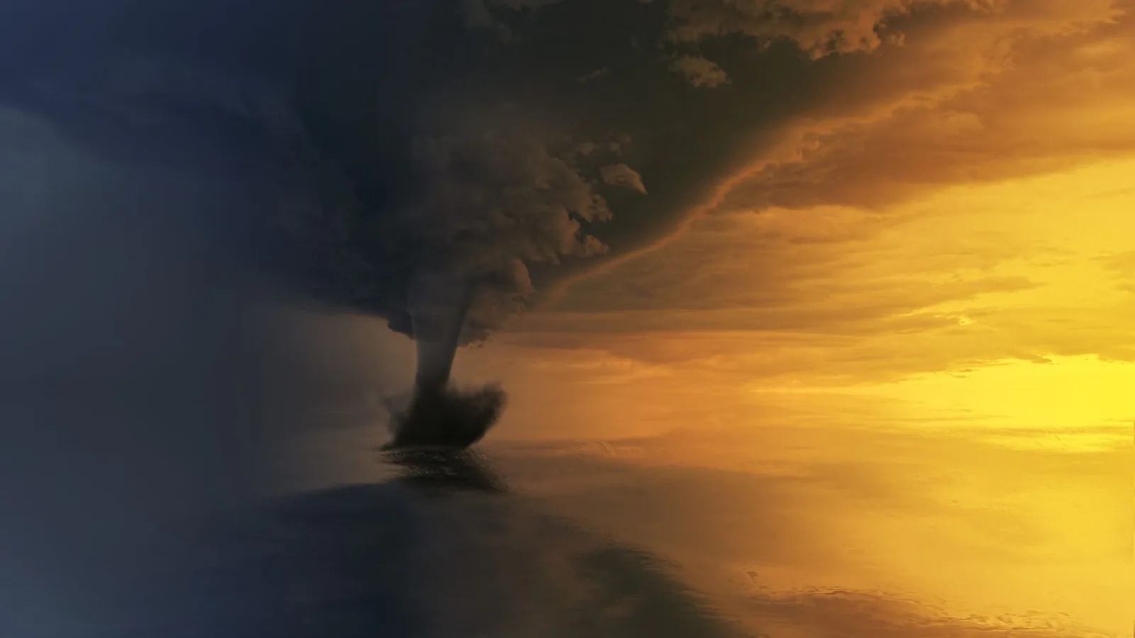 A tornado over water under a dramatic sunset sky