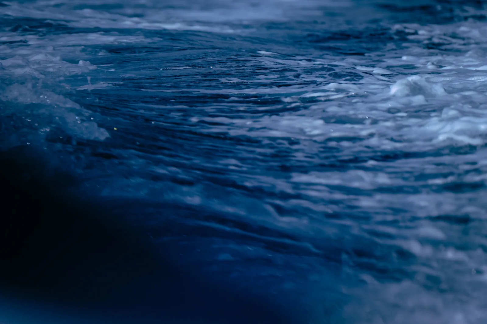 Stormy waves on a dark, desaturated sea