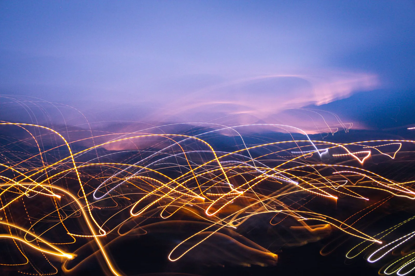 Blurred blue-violet light trails in the dark