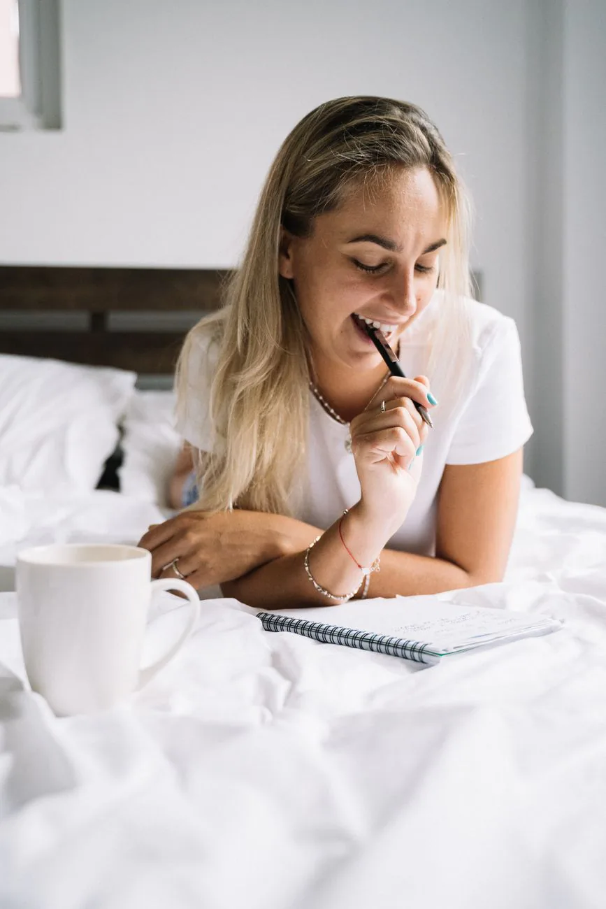 Woman writing in a journal in soft morning light