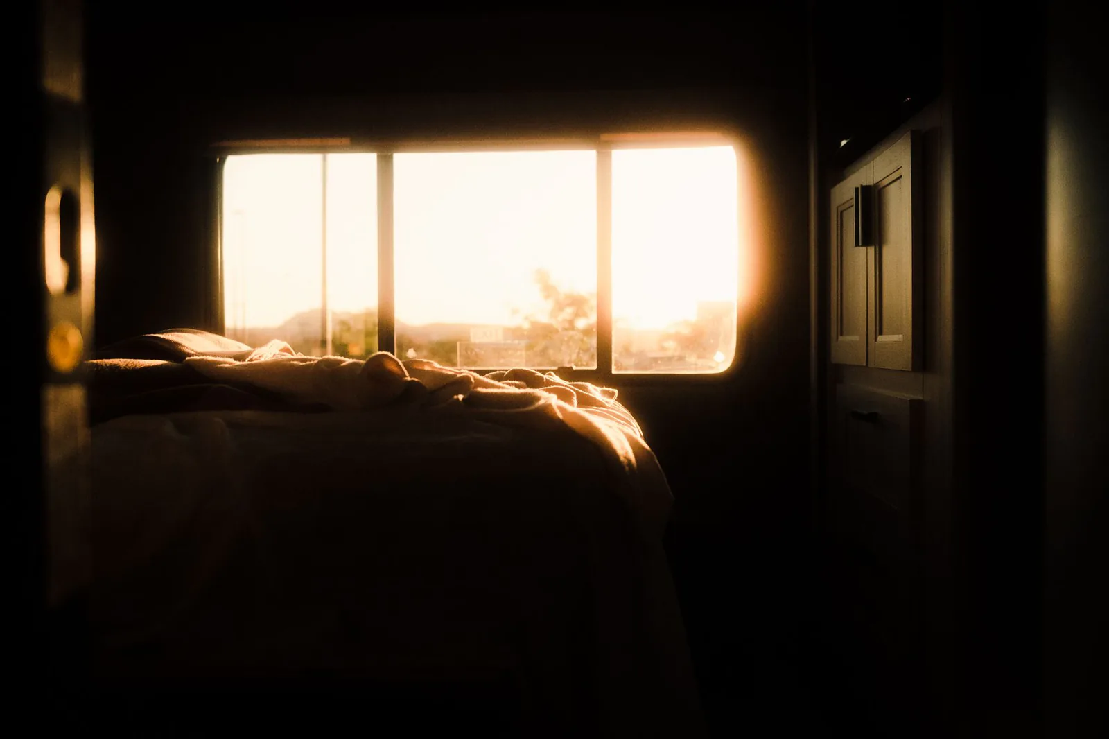 Warm morning sunlight streaming through a bedroom window